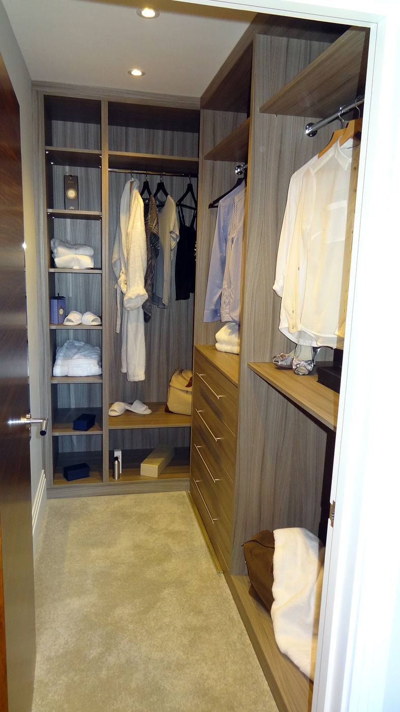 Woodgrain walk-in wardrobe viewed from the doorway
