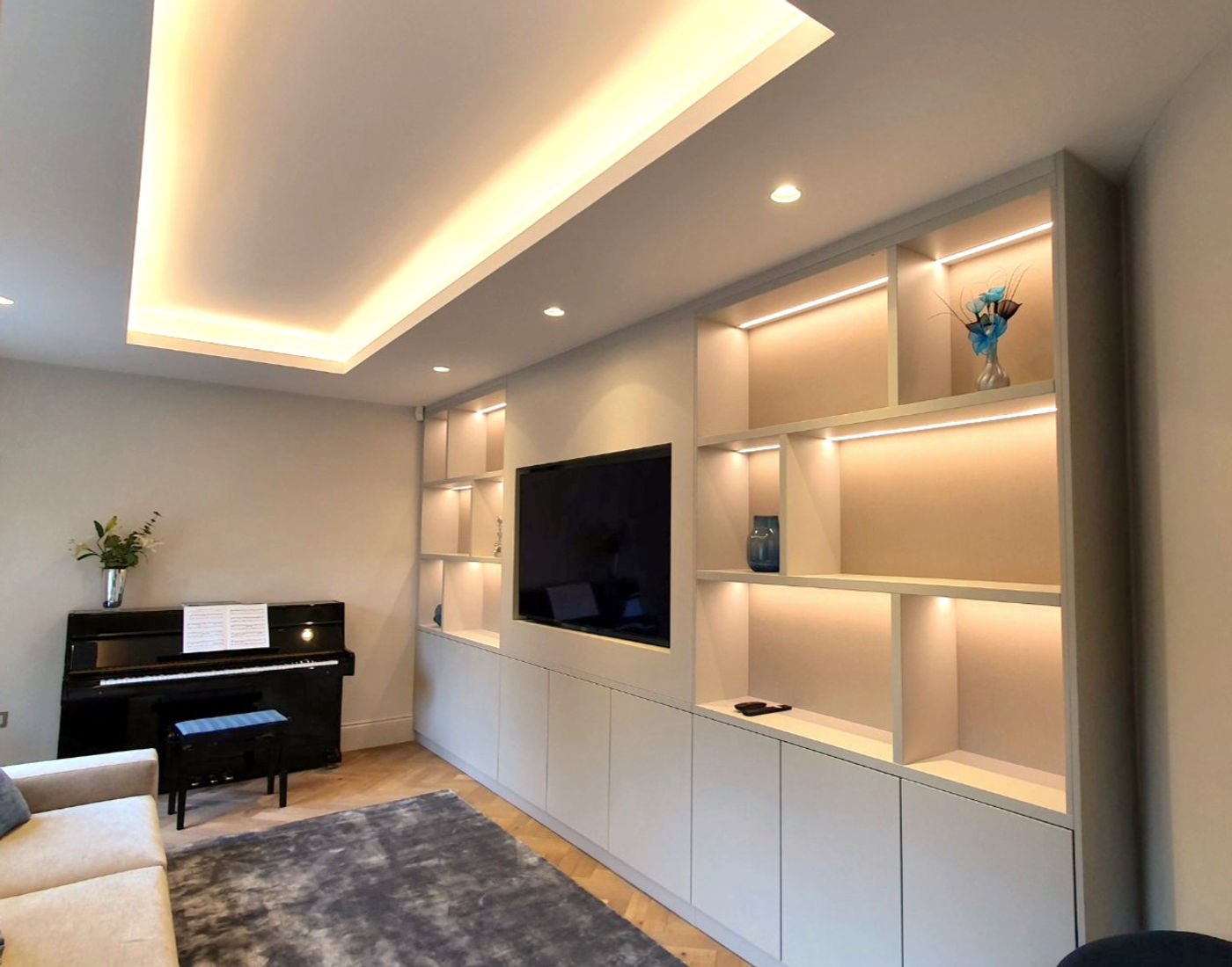 Fitted living-room cabinetry with display shelving and television space