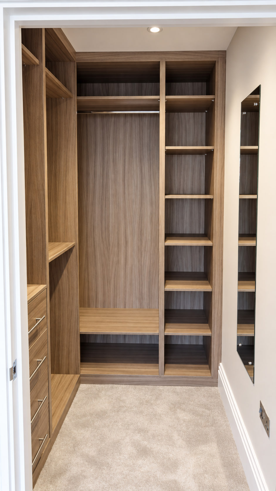 Woodgrain fitted wardrobe interior in a completed bedroom