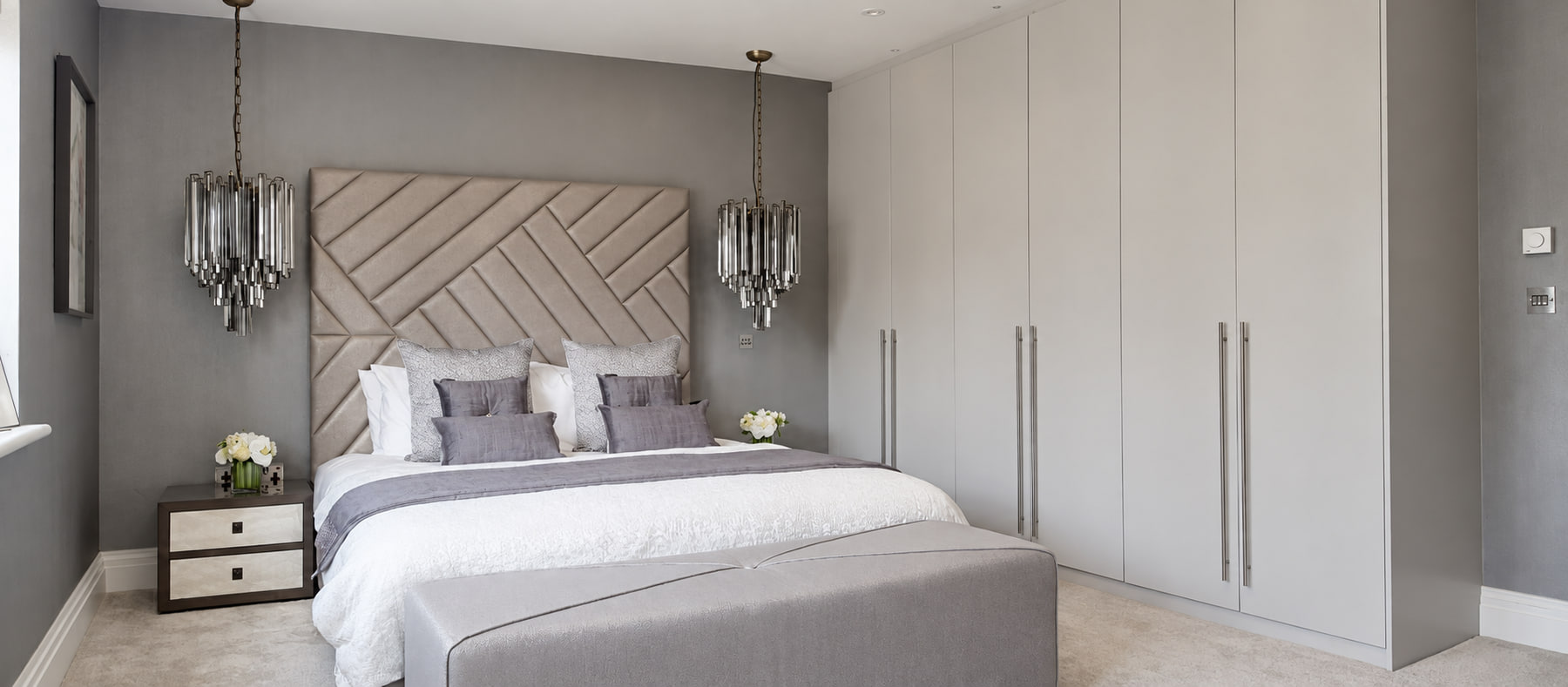 Completed light-grey fitted wardrobes within a bedroom