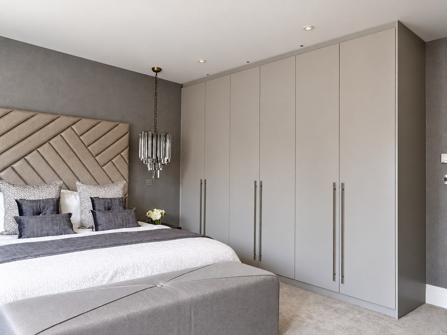 Fitted wardrobes shaped beneath a sloping bedroom ceiling