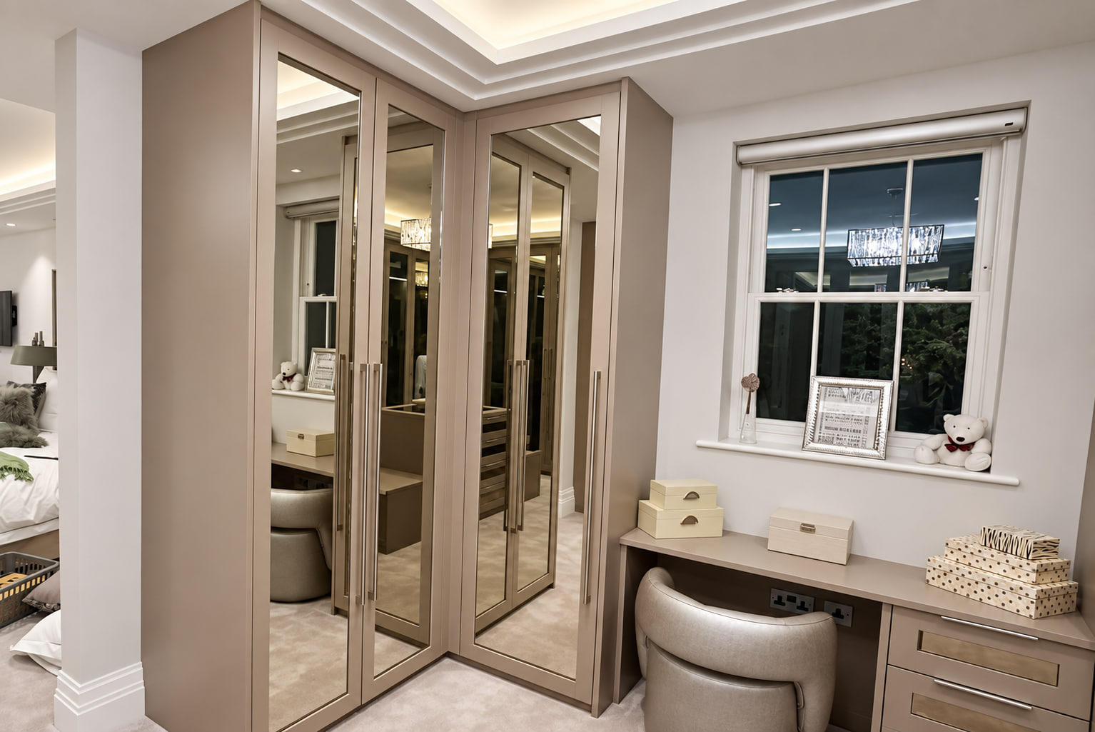 Taupe mirrored wardrobes beside a fitted dressing table