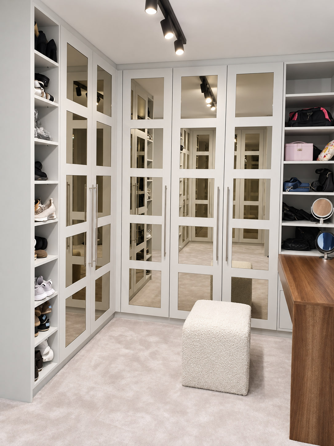White mirrored walk-in wardrobe with shoe storage